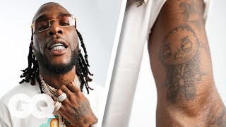 Burna Boy Breaks Down His Tattoos  GQ [upl. by Iclek]